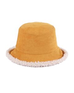 Wholesale, reversible, faux sheepskin bucket hat in mustard. 